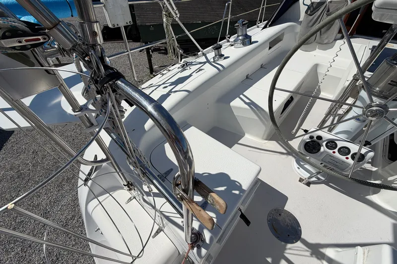 Slide: The Image of Cockpit view of a 2003 Catalina 380 sailboat, featuring steering wheel and control panel. - 29