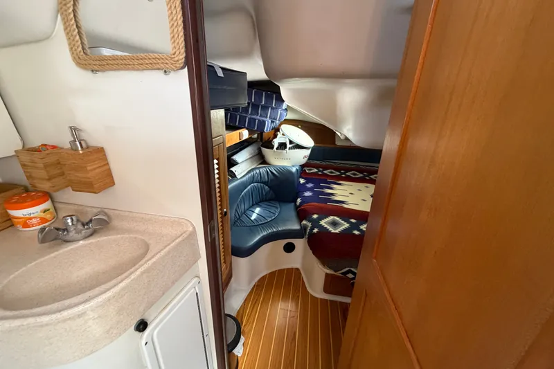 Slide: The Image of Interior of a 2003 Catalina 380 sailboat with cozy cabin and compact sink area. - 13