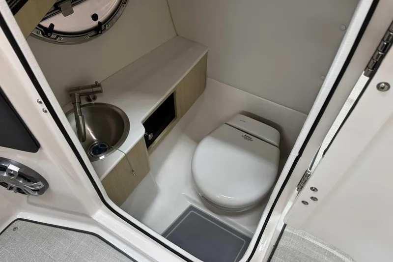 Slide: The Image of Compact bathroom in 2025 Regal LS6 boat with sink and toilet. - 10