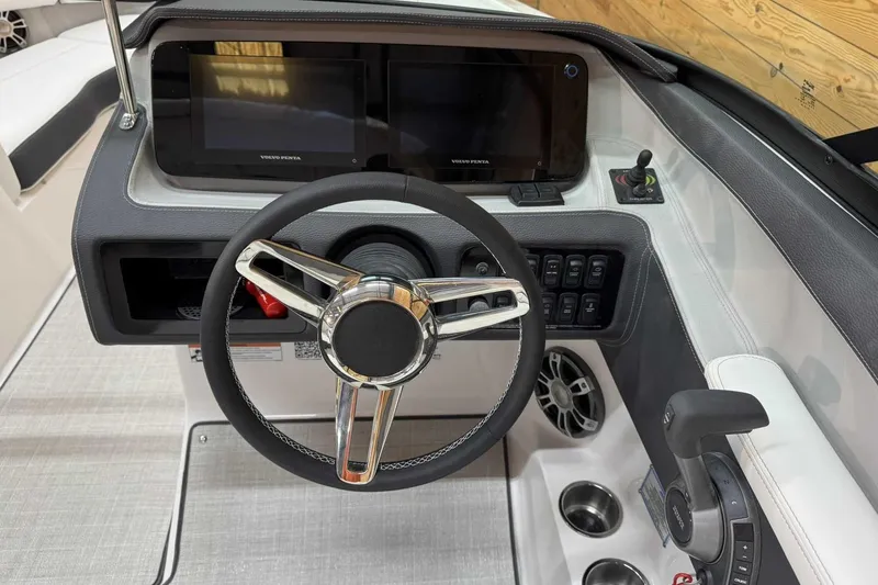 Slide: The Image of 2025 Regal LS6 boat dashboard with steering wheel, dual screens, and control panel. - 8