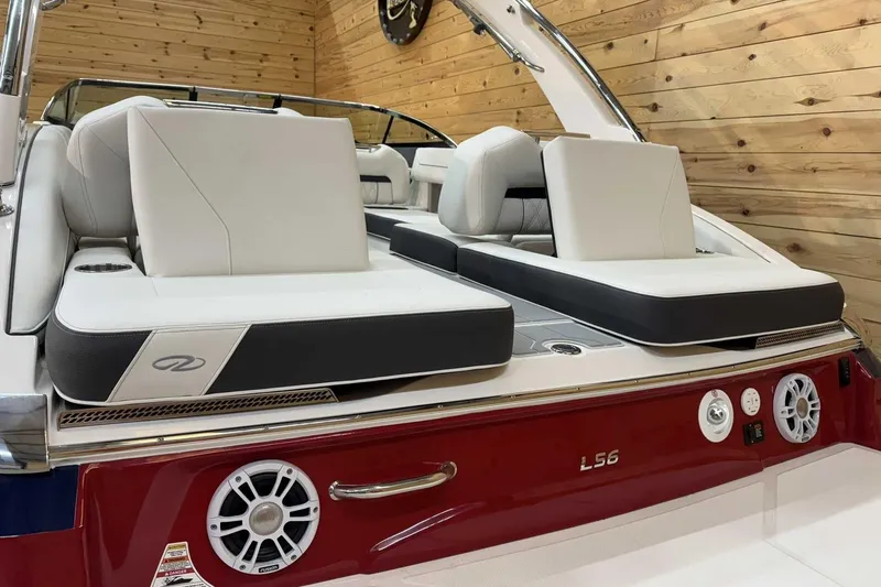 Slide: The Image of 2025 Regal LS6 boat interior with luxurious seating and modern design in a wooden setting. - 5