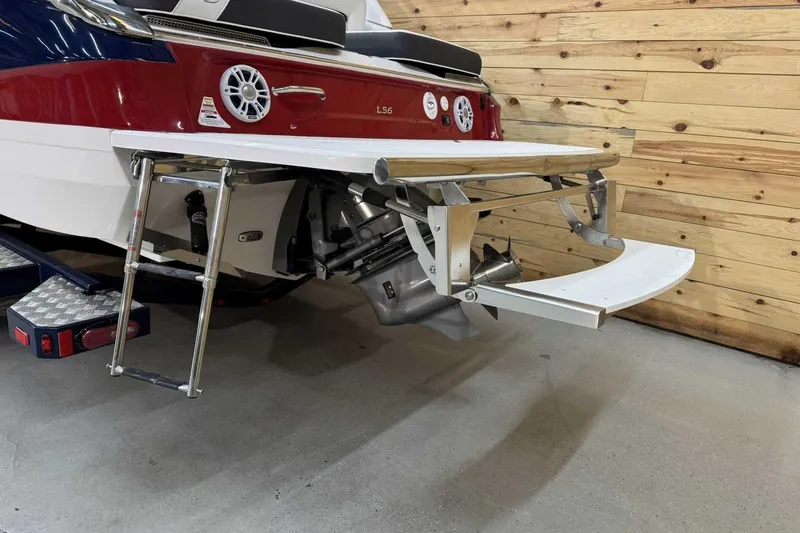 Slide: The Image of 2025 Regal LS6 boat with swim platform and ladder in a wooden garage. - 3