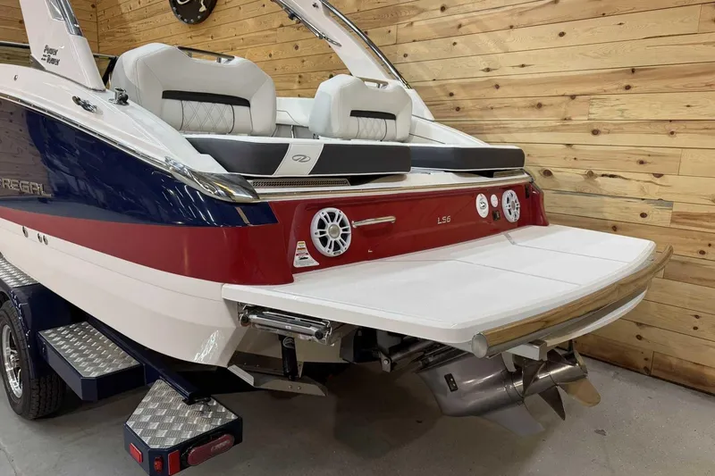 Slide: The Image of 2025 Regal LS6 boat with sleek design, featuring a spacious swim platform and luxurious seating. - 2