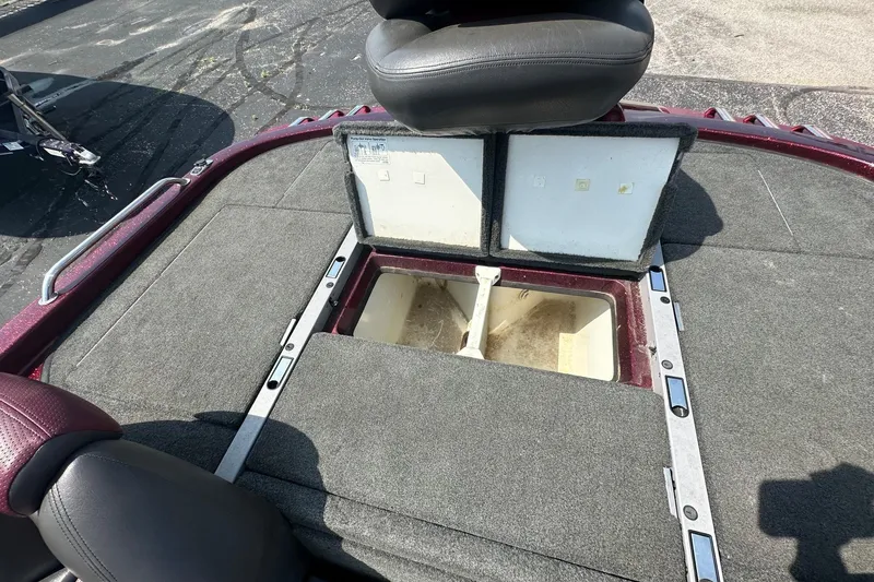 Slide: The Image of The image shows the deck of a 2006 Ranger Z20 Comanche boat with storage compartments. - 14