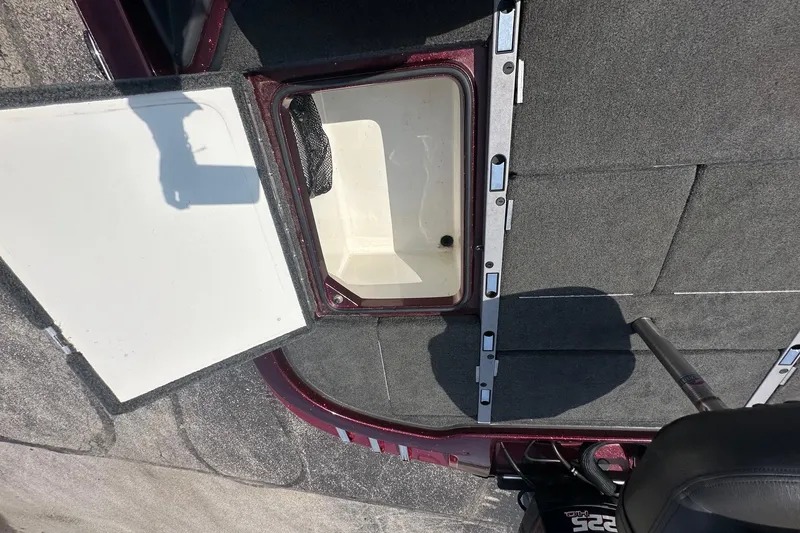 Slide: The Image of Open storage compartment on a 2006 Ranger Z20 Comanche boat, showing interior details. - 12