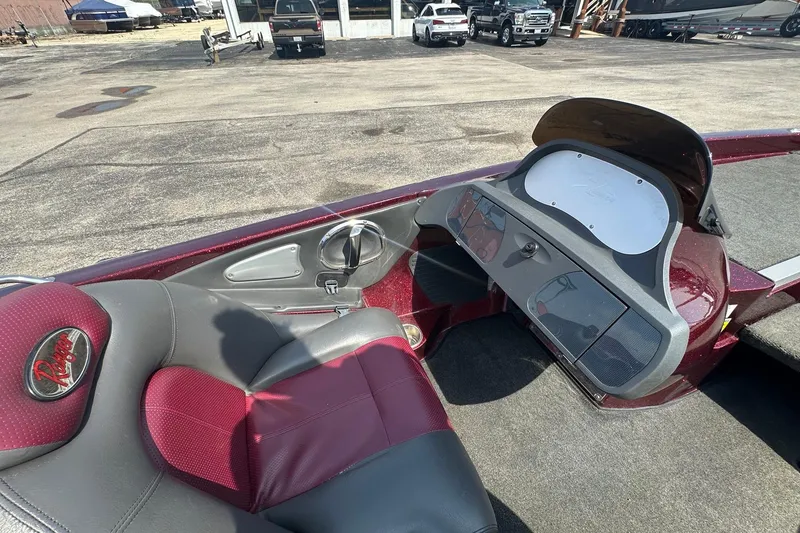 Slide: The Image of 2006 Ranger Z20 Comanche boat interior with maroon and gray seating, dashboard view. - 5