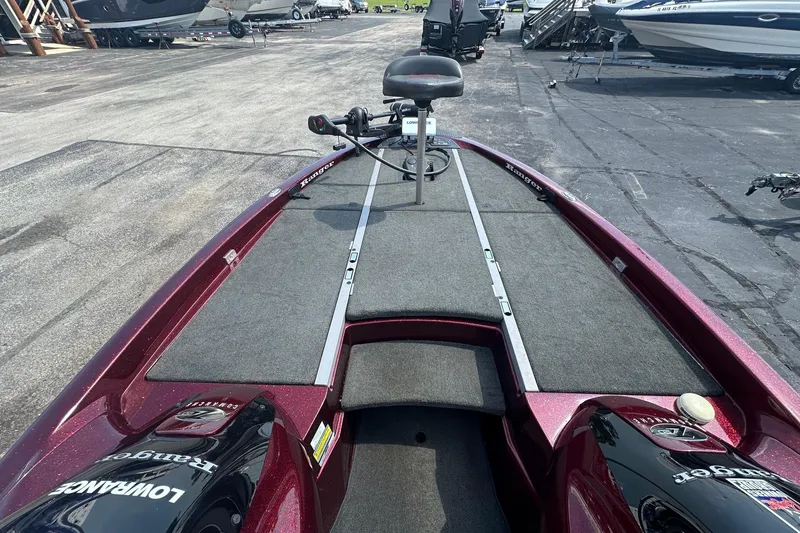 Slide: The Image of 2006 Ranger Z20 Comanche boat with fishing deck and trolling motor in a marina setting. - 9
