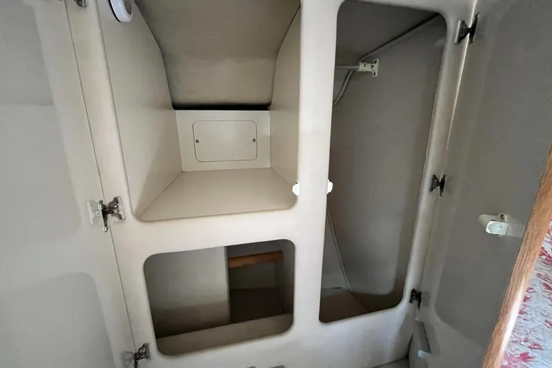 Slide: The Image of Interior storage compartments of a 1995 Sea Ray Sundancer 330 boat. - 19