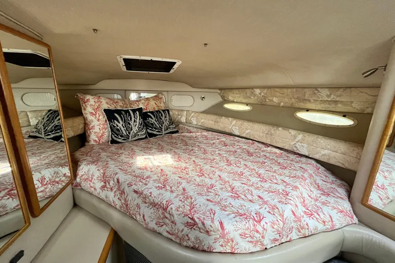 Slide: The Image of Interior cabin of a 1995 Sea Ray Sundancer 330 with coral-themed bedding. - 13