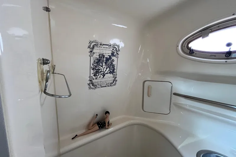 Slide: The Image of Interior of 1995 Sea Ray Sundancer 330 boat with porthole and decorative elements. - 18