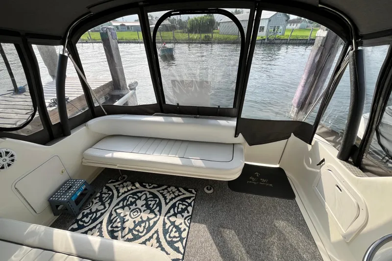 Slide: The Image of Interior of a 1995 Sea Ray Sundancer 330 boat with seating and waterfront view. - 11