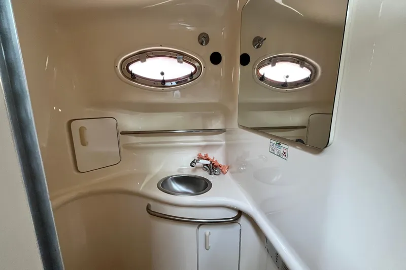 Slide: The Image of 1995 Sea Ray Sundancer 330 bathroom interior with sink and porthole window. - 17