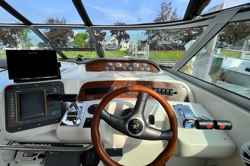 Slide: The Image of 1995 Sea Ray Sundancer 330 helm with steering wheel, controls, and navigation equipment. - 8