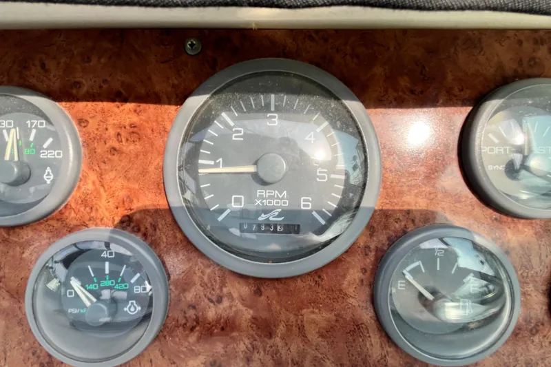 Slide: The Image of Dashboard gauges of a 1995 Sea Ray Sundancer 330 boat, featuring RPM and fuel indicators. - 9