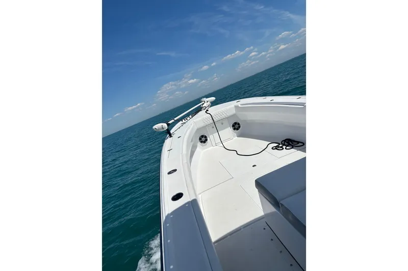 Slide: The Image of 1995 Intrepid 323 Open boat cruising on clear blue ocean under sunny sky. - 4