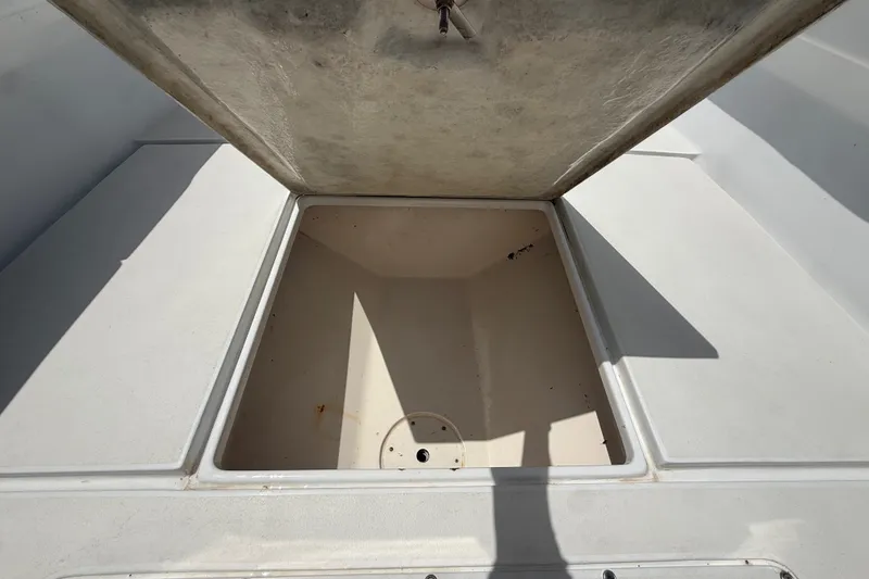 Slide: The Image of Open storage compartment on a 1995 Intrepid 323 Open boat, showcasing spacious interior. - 37