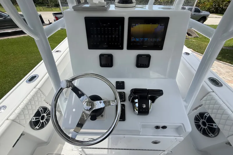 Slide: The Image of Control panel of a 1995 Intrepid 323 Open boat with steering wheel and navigation screens. - 20