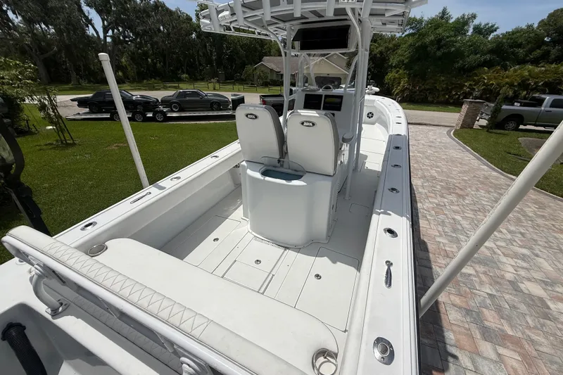 Slide: The Image of 1995 Intrepid 323 Open boat with spacious deck and modern console, parked on a driveway. - 9