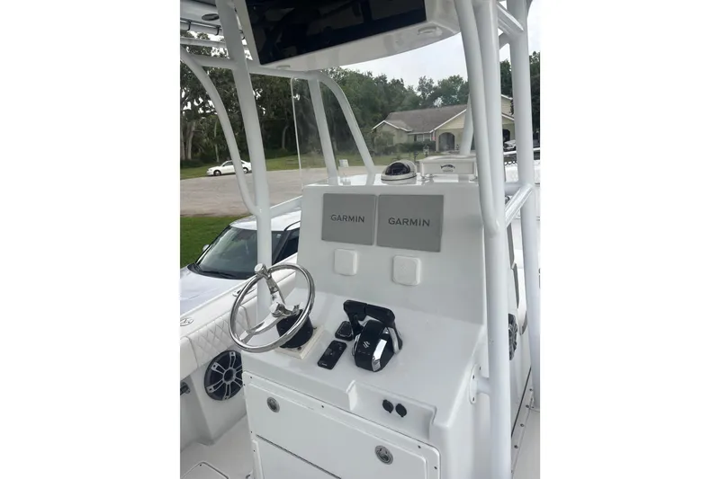 Slide: The Image of 1995 Intrepid 323 Open boat console with Garmin navigation systems and steering wheel. - 9