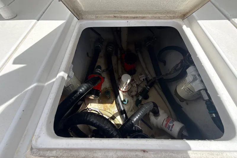 Slide: The Image of Open hatch of a 1995 Intrepid 323 Open boat showing internal components and wiring. - 66