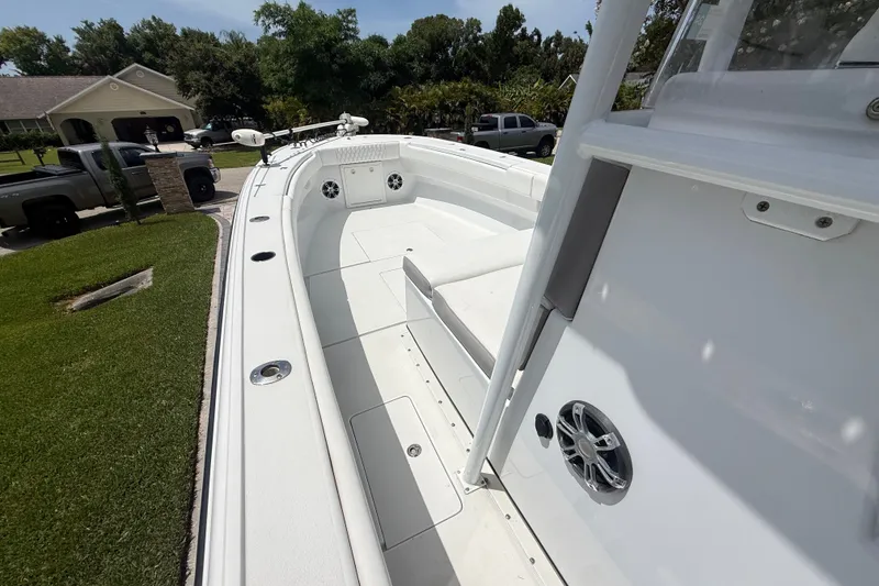 Slide: The Image of 1995 Intrepid 323 Open boat with spacious deck and modern features, parked in a residential area. - 31