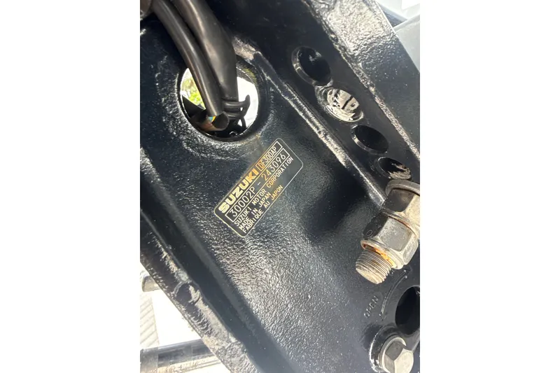 Slide: The Image of Close-up of a Suzuki engine part on a 1995 Intrepid 323 Open boat. - 80
