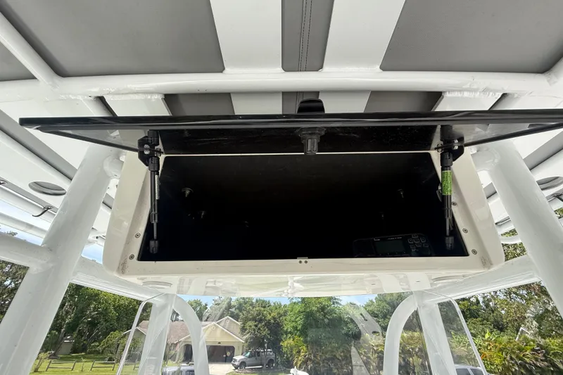 Slide: The Image of Open storage compartment on a 1995 Intrepid 323 Open boat, showcasing interior details. - 25