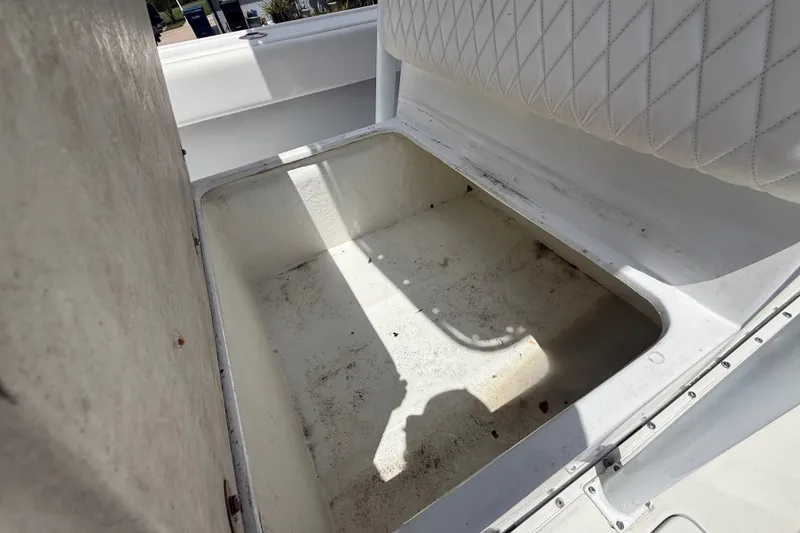 Slide: The Image of Storage compartment on a 1995 Intrepid 323 Open boat, featuring white interior. - 51