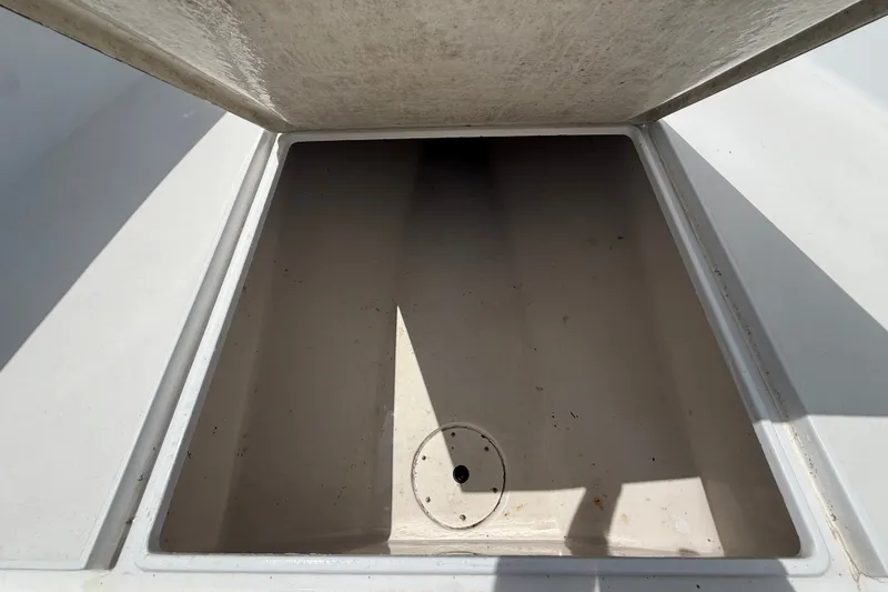 Slide: The Image of Open storage compartment on a 1995 Intrepid 323 Open boat, showing interior space. - 39
