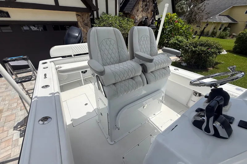 Slide: The Image of 1995 Intrepid 323 Open boat interior with dual white quilted seats and steering console. - 57