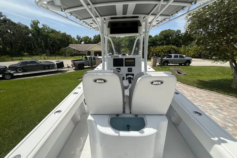 Slide: The Image of 1995 Intrepid 323 Open boat interior with dual seats and control panel, parked outdoors. - 12