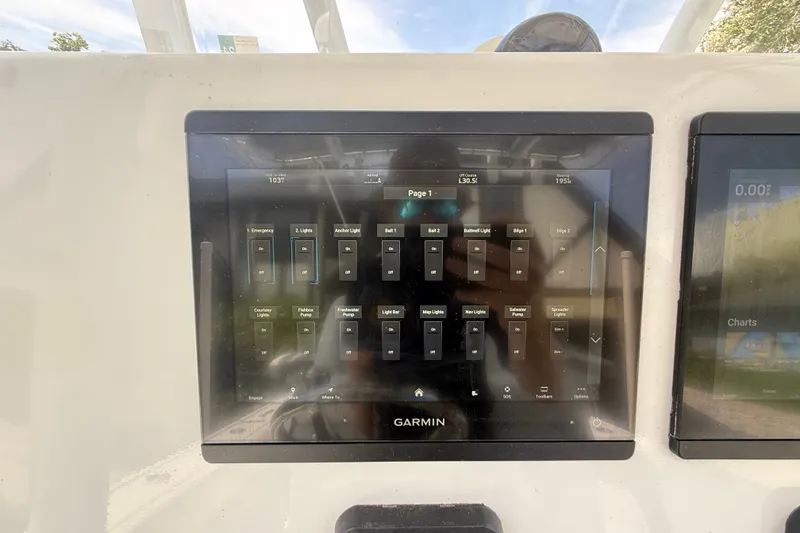 Slide: The Image of Garmin touchscreen display on a 1995 Intrepid 323 Open boat, showing control panel interface. - 23