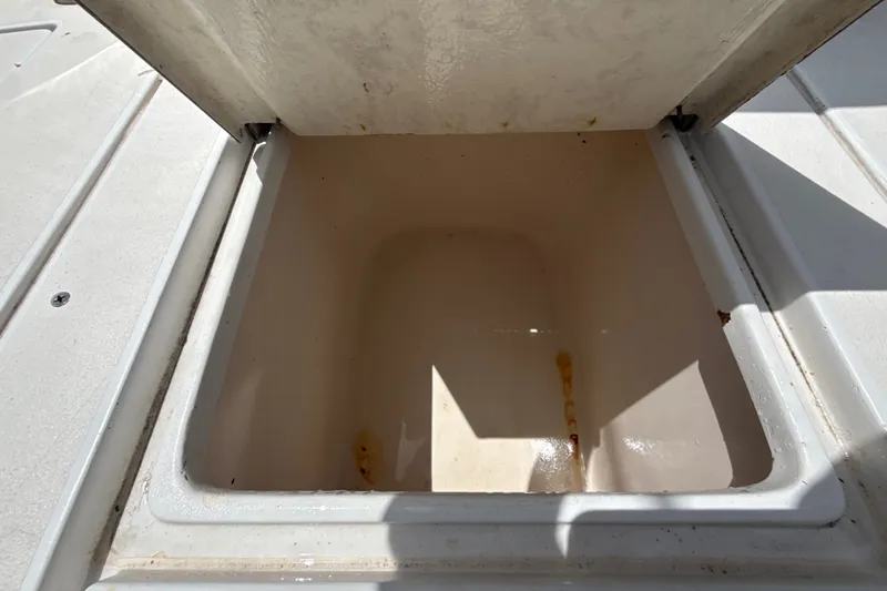 Slide: The Image of Open storage compartment on a 1995 Intrepid 323 Open boat, showing interior space. - 71