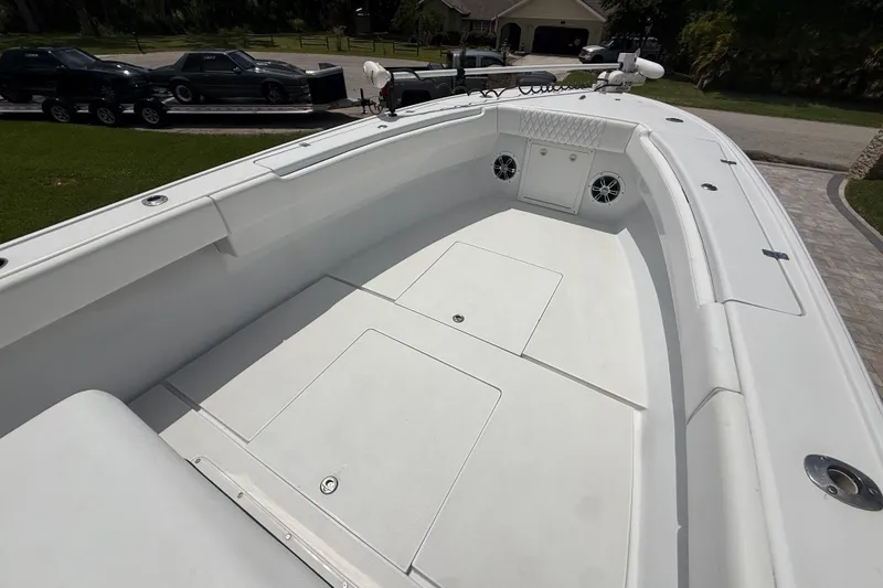 Slide: The Image of 1995 Intrepid 323 Open boat deck with storage compartments and speakers. - 34