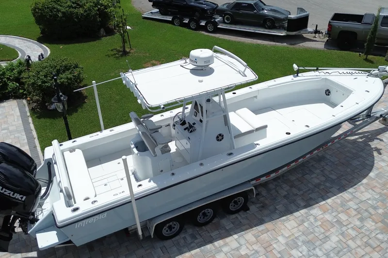 Slide: The Image of 1995 Intrepid 323 Open boat on trailer, parked on paved driveway. - 6
