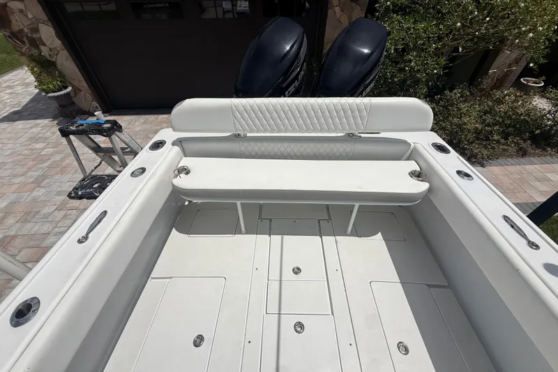 Slide: The Image of 1995 Intrepid 323 Open boat interior with white seating and dual outboard motors. - 63