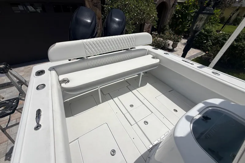 Slide: The Image of 1995 Intrepid 323 Open boat interior with white seating and dual outboard motors. - 60