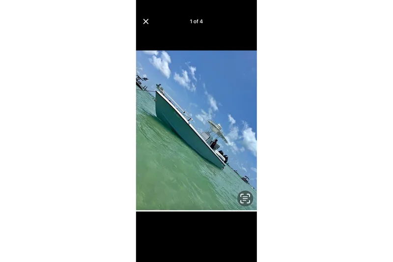 Slide: The Image of A 1995 Intrepid 323 Open boat on clear turquoise water under a blue sky. - 3