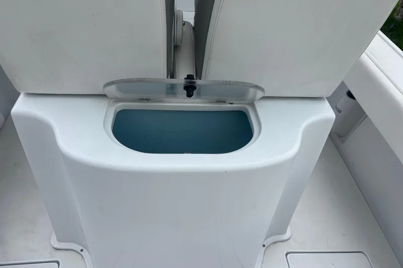 Slide: The Image of 1995 Intrepid 323 Open boat interior with storage compartment and white seating. - 8