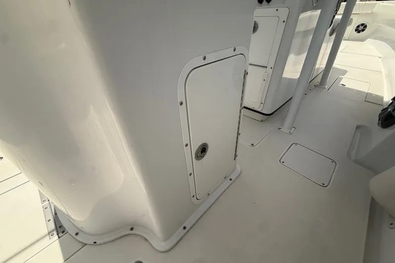 Slide: The Image of Interior view of a 1995 Intrepid 323 Open boat, featuring white storage compartments. - 16