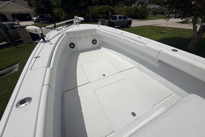 Slide: The Image of 1995 Intrepid 323 Open boat deck, spacious and well-maintained, parked in a residential area. - 33