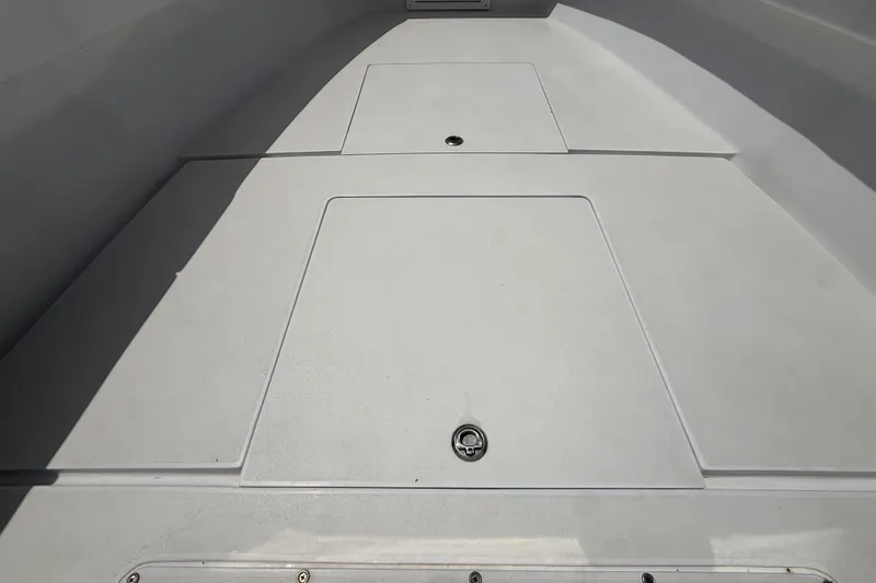 Slide: The Image of Deck view of a 1995 Intrepid 323 Open boat, featuring storage compartments. - 36