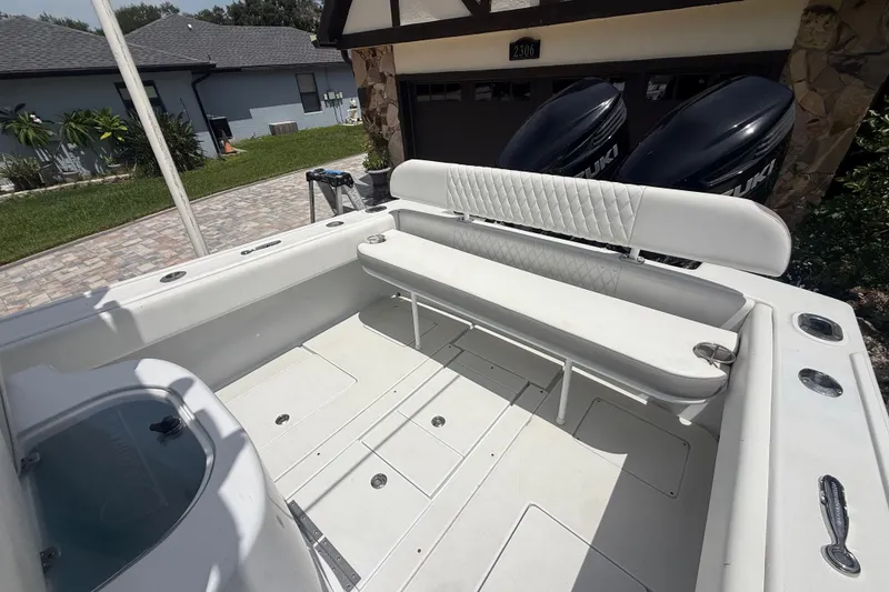 Slide: The Image of 1995 Intrepid 323 Open boat interior with white seating and dual Suzuki engines. - 69