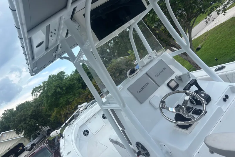 Slide: The Image of 1995 Intrepid 323 Open boat cockpit with Garmin navigation, steering wheel, and controls. - 13