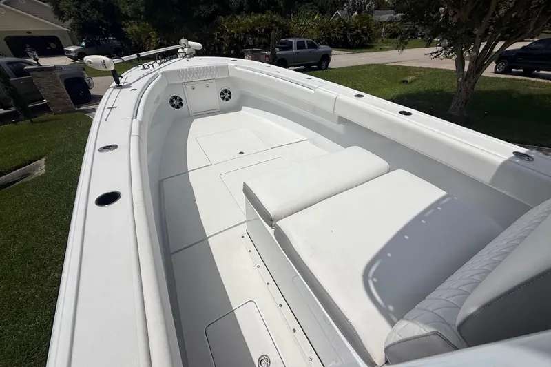 Slide: The Image of 1995 Intrepid 323 Open boat interior with white seating and spacious deck. - 32