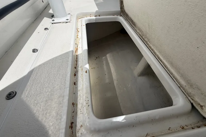 Slide: The Image of Open storage compartment on a 1995 Intrepid 323 Open boat, showing interior details. - 55
