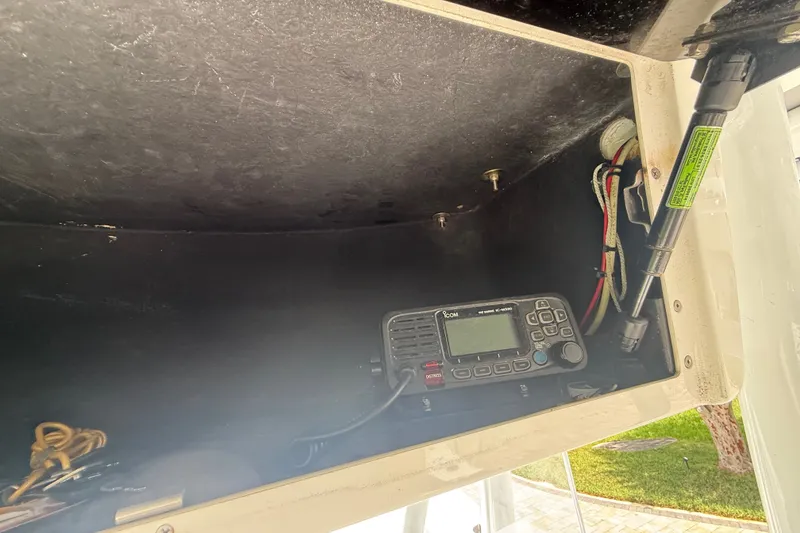 Slide: The Image of Storage compartment with radio equipment on a 1995 Intrepid 323 Open boat. - 26