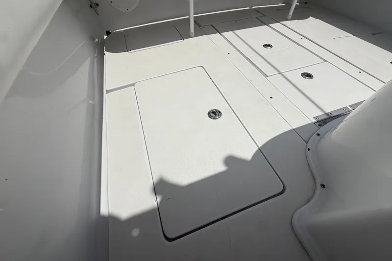 Slide: The Image of Deck of a 1995 Intrepid 323 Open boat with storage compartments. - 61