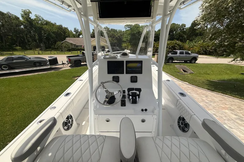 Slide: The Image of 1995 Intrepid 323 Open boat cockpit with steering wheel and control panel. - 19