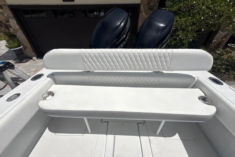 Slide: The Image of 1995 Intrepid 323 Open boat interior with white cushioned seating and cup holders. - 64